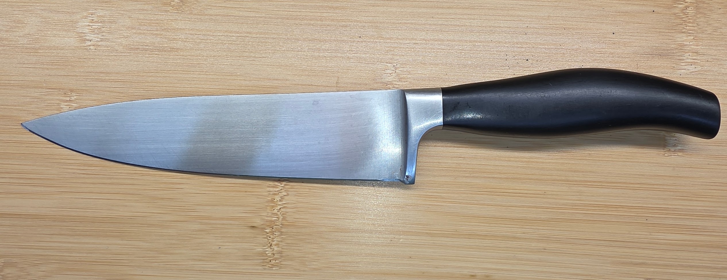 Full-bolster chef knife before bolster reduction and heel repair